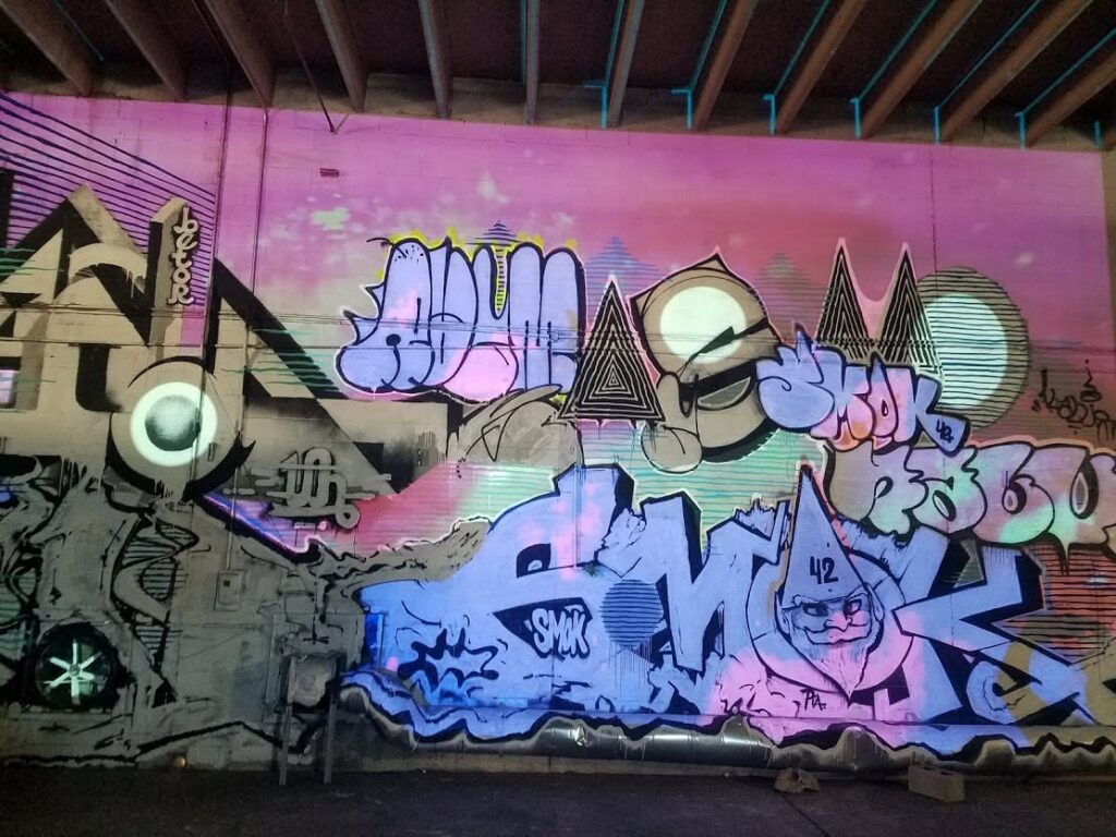 Close-up of the graffiti wall with pink and purple light projections at Nashville Night Market